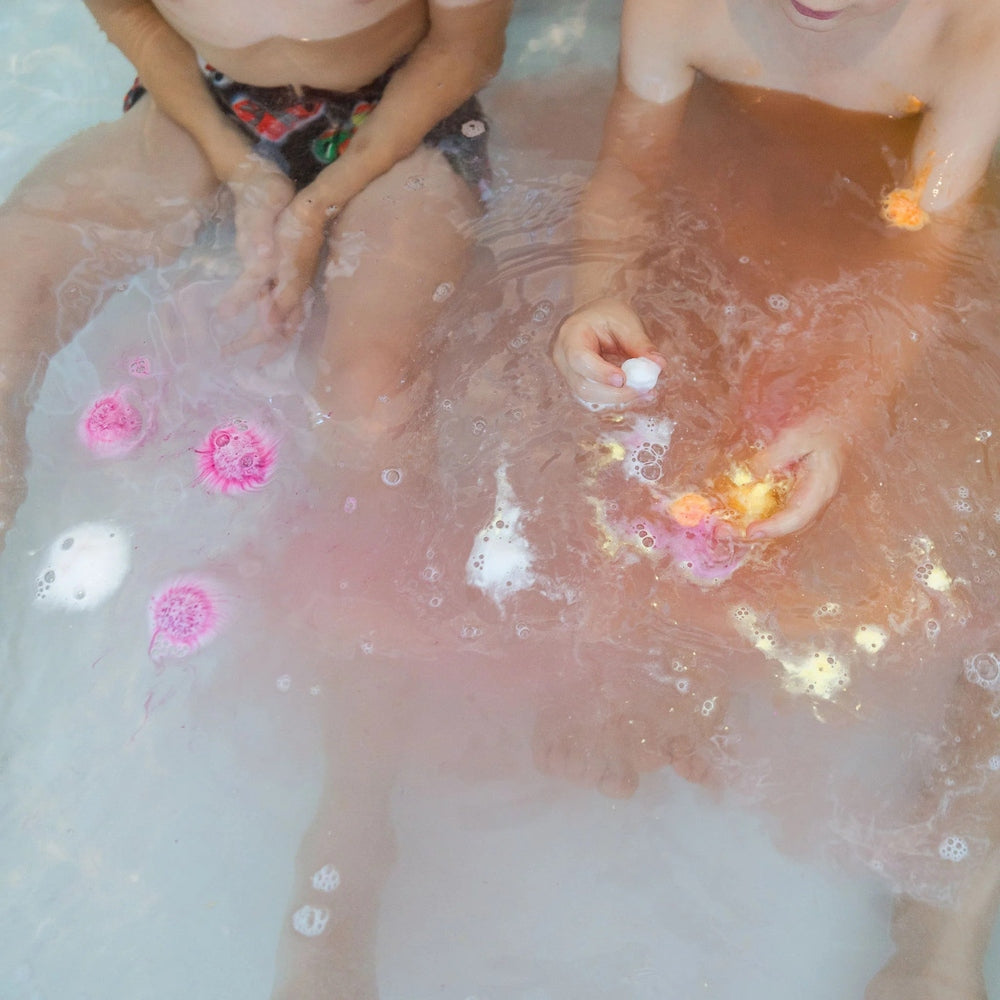 LOOT TOY CO Funky Fish Food Swoon Maroon bath product in pink-maroon water with kids playing