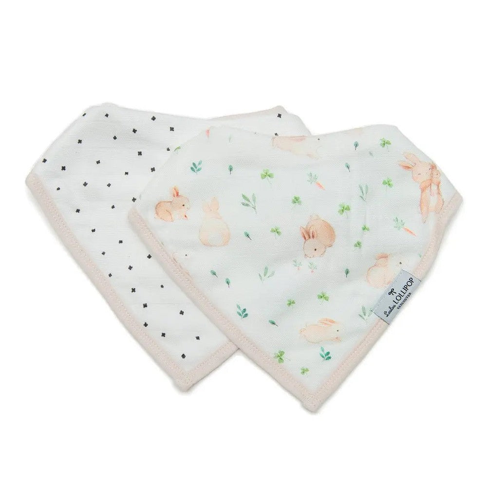 Loulou Lollipop Bandana Bib Set: two pastel bunny-print bibs laid flat to reveal greenery pattern and soft trim.