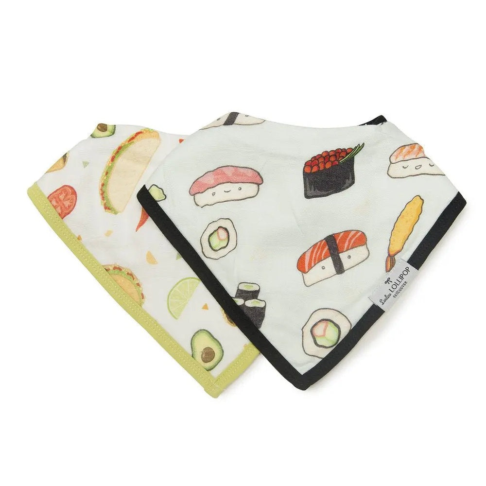 Loulou Lollipop Bandana Bib Set, 2-pack sushi-print bibs laid flat in cream with black and lime trim.