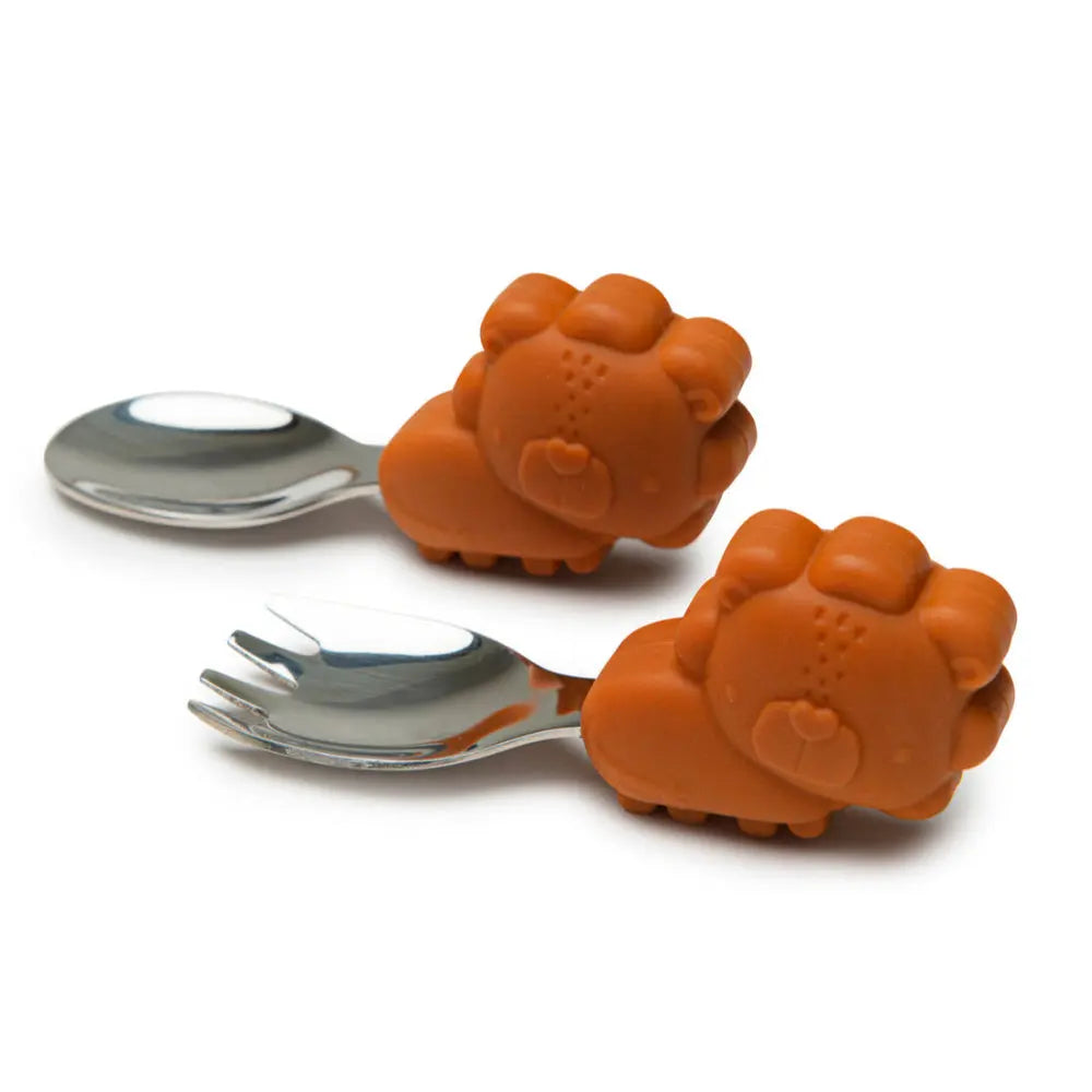 Loulou Lollipop Born To Be Wild Learning Spoon/Fork Set with orange bear-shaped handles, shown resting beside forks.