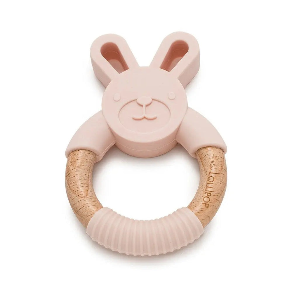 Loulou Lollipop Bunny Silicone And Wood Teether in pink, bunny head atop a wooden ring being gripped.