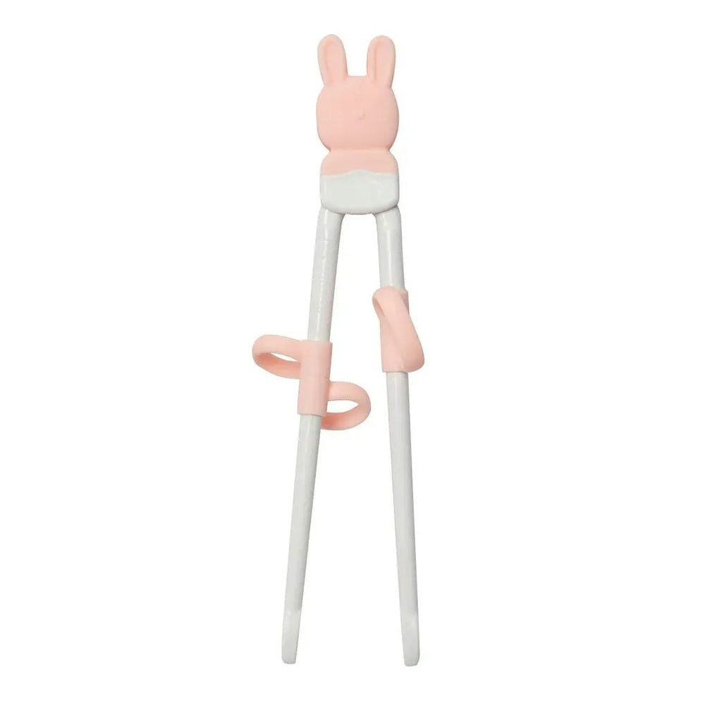 Loulou Lollipop Chopsticks for toddlers, pink bunny-top training sticks with finger rings in use.