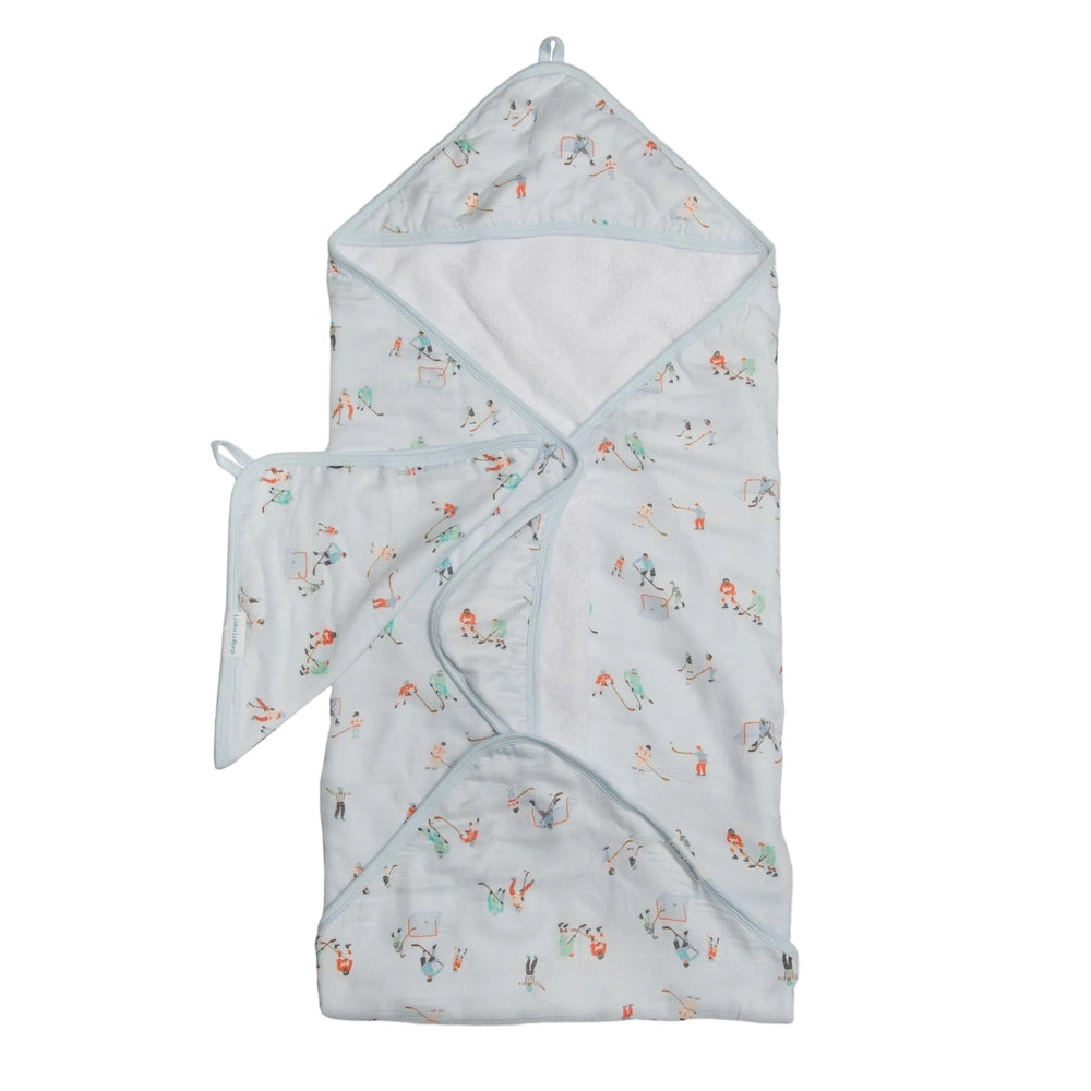 LOULOU LOLLIPOP Hooded Towel Set; pale blue with playful print, baby wrapped in the hooded bath towel.