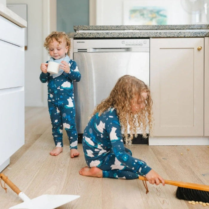 Loulou Lollipop Long Sleeve Pajama Set Stargazing Bear in blue starry print; kids play indoors in a sunlit kitchen.