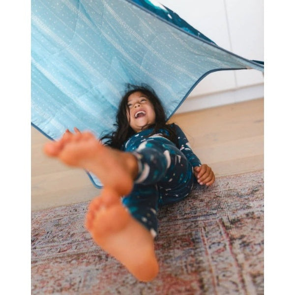 LOULOU LOLLIPOP Long Sleeve Pajama Set Stargazing Bear; blue star print cozy sleepwear, shown as child giggles under a tent.