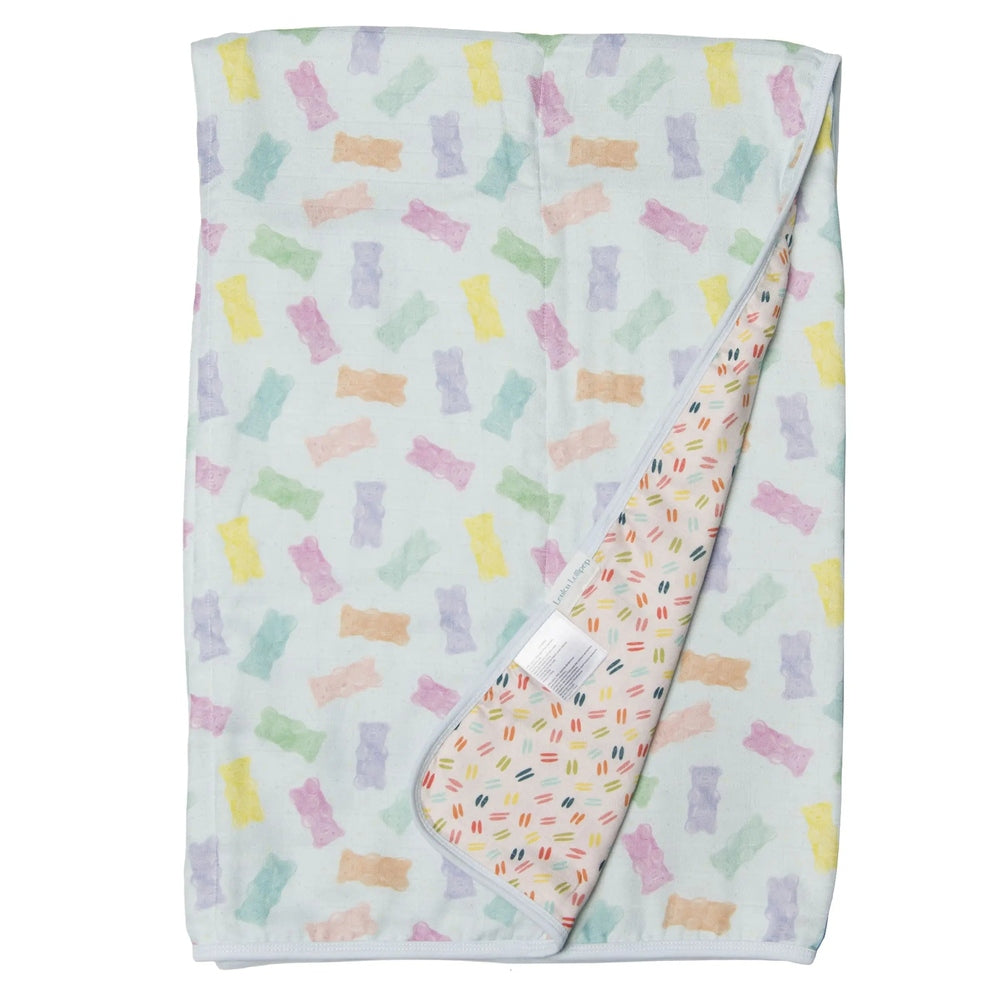LOULOU LOLLIPOP Muslin Quilt Blanket in pastel bone print with a sprinkle reverse, shown folded to reveal soft muslin.