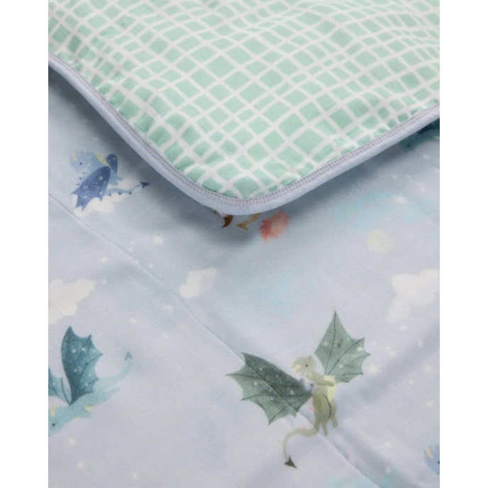 Loulou Lollipop Muslin Quilt Blanket, mint grid on soft pastel blue fabric with edge binding visible as it lies open.