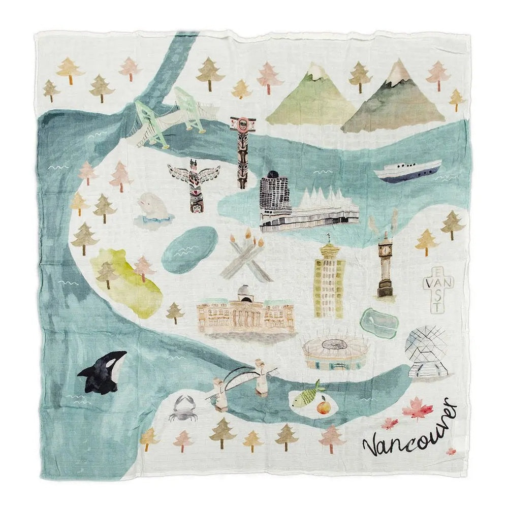 Loulou Lollipop Muslin Quilt Blanket with pastel Vancouver cityscape laid flat over mountains and water.