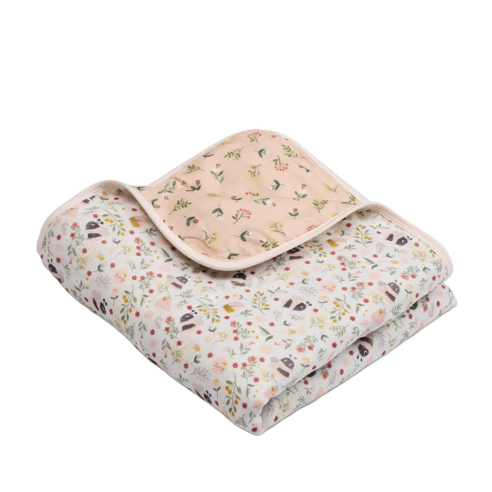 LOULOU LOLLIPOP Muslin Quilt Blanket, peach floral top layered over a floral base, ready for swaddling.