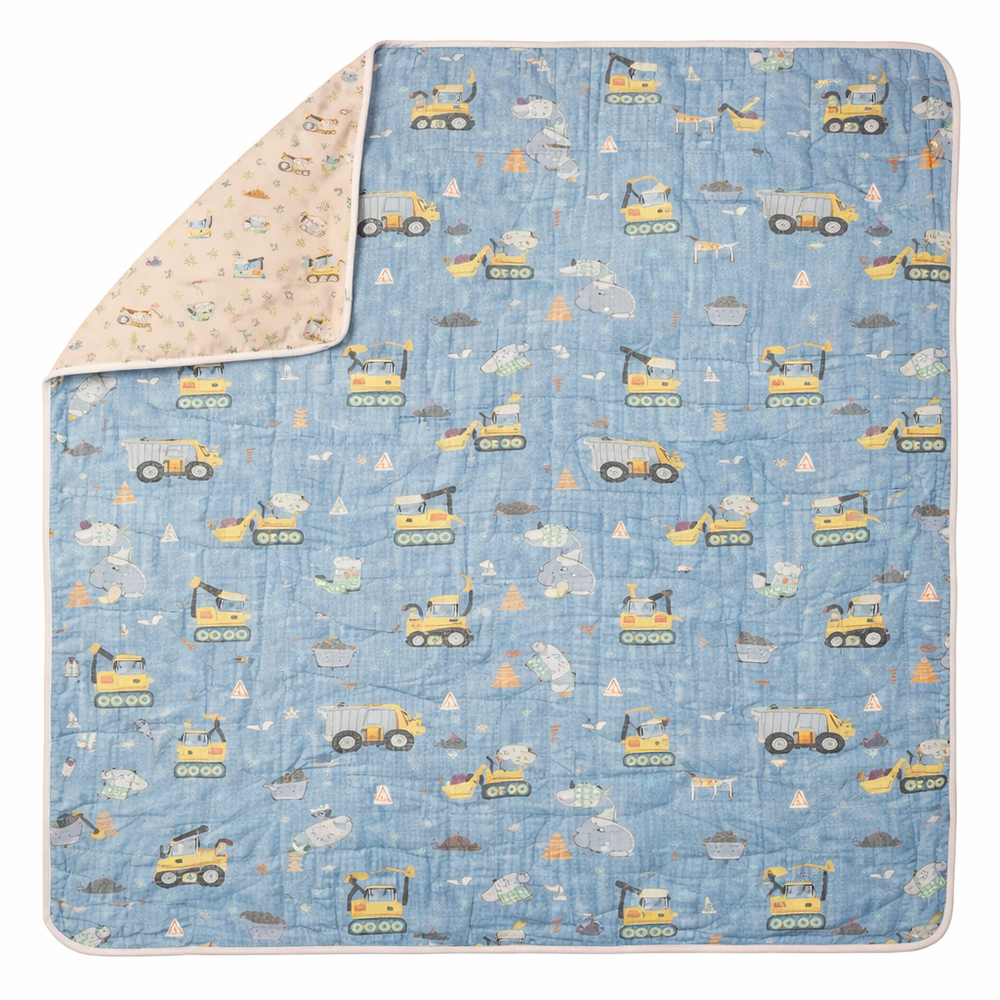 Loulou Lollipop Muslin Quilt Blanket in Blue with construction-truck print and pink reverse.