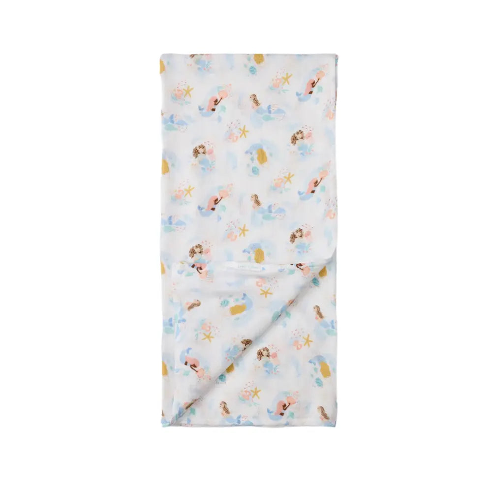 Loulou Lollipop Muslin Swaddle blanket in pastel mermaid print, soft cotton draped for baby wrap.