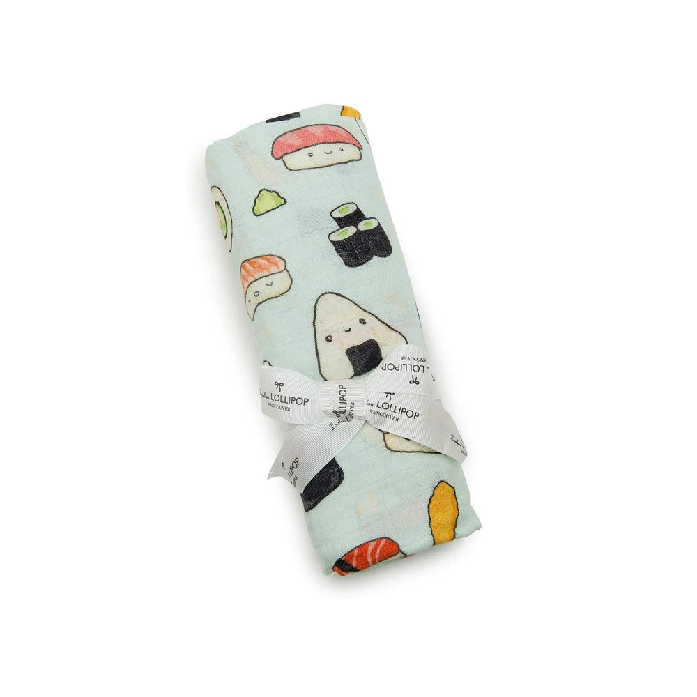 LOULOU LOLLIPOP Muslin Swaddle in pale blue sushi print, neatly rolled and tied with branded ribbon.