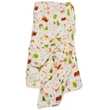 Loulou Lollipop Muslin Swaddle blanket in woodland animal print on white; shown wrapped for a cozy swaddle.