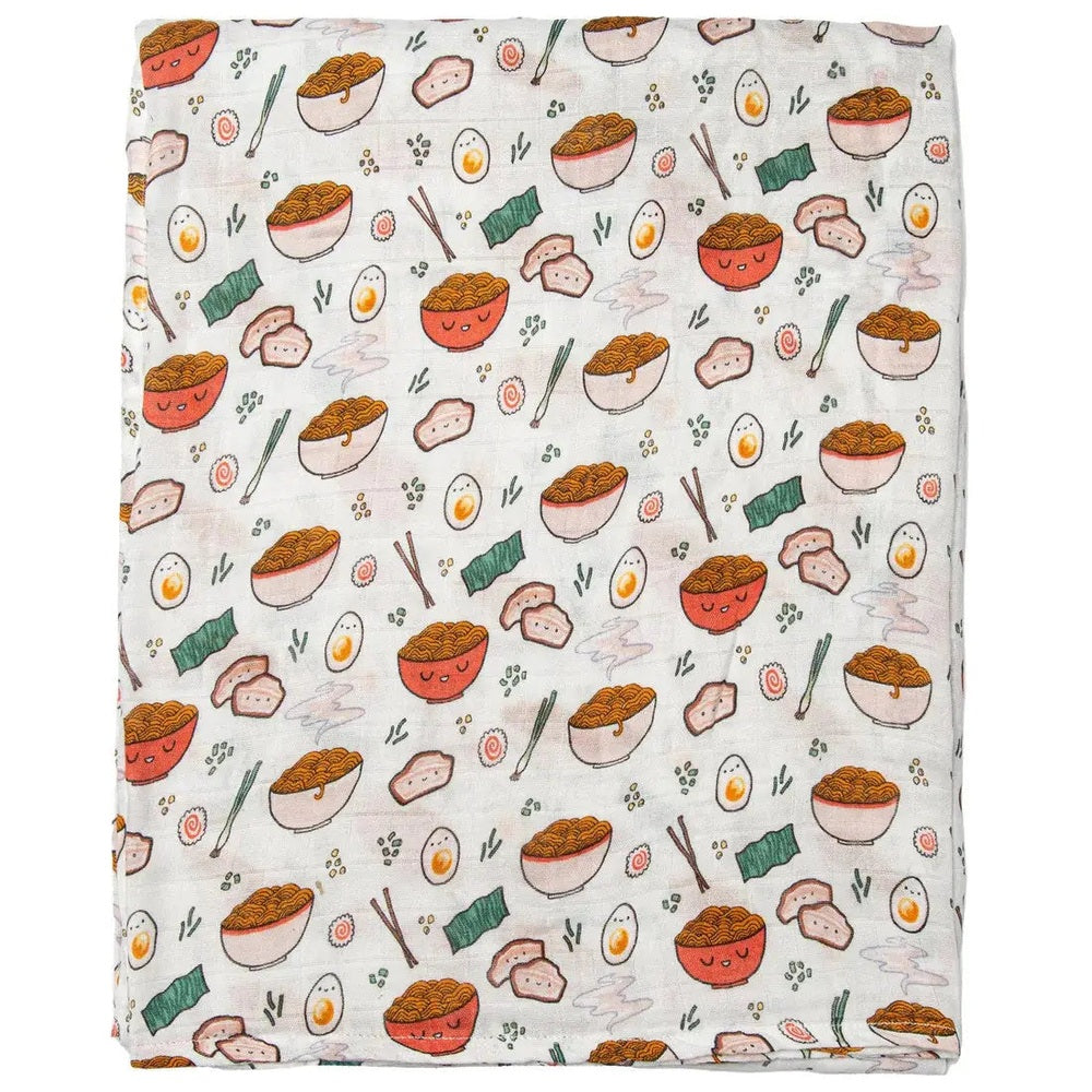 Loulou Lollipop Muslin Swaddle blanket laid flat in white with cheerful bowls, eggs and chopsticks print.