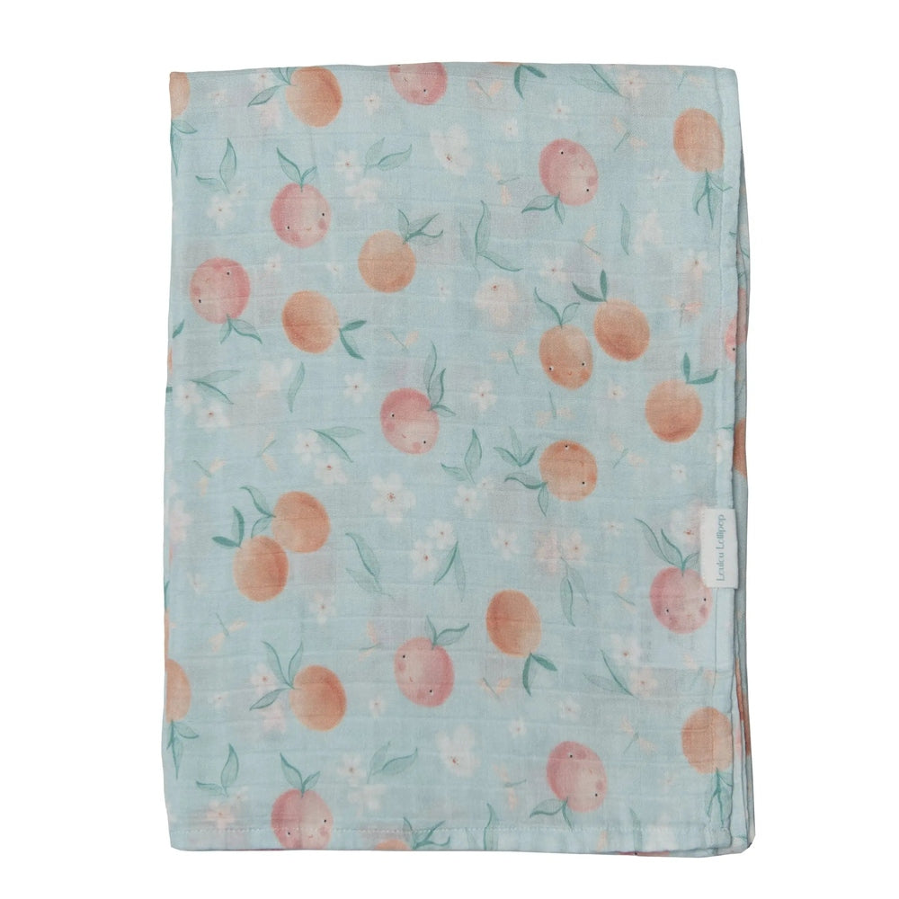 Loulou Lollipop Muslin Swaddle blanket in pale blue peach pattern, folded flat with brand tag visible