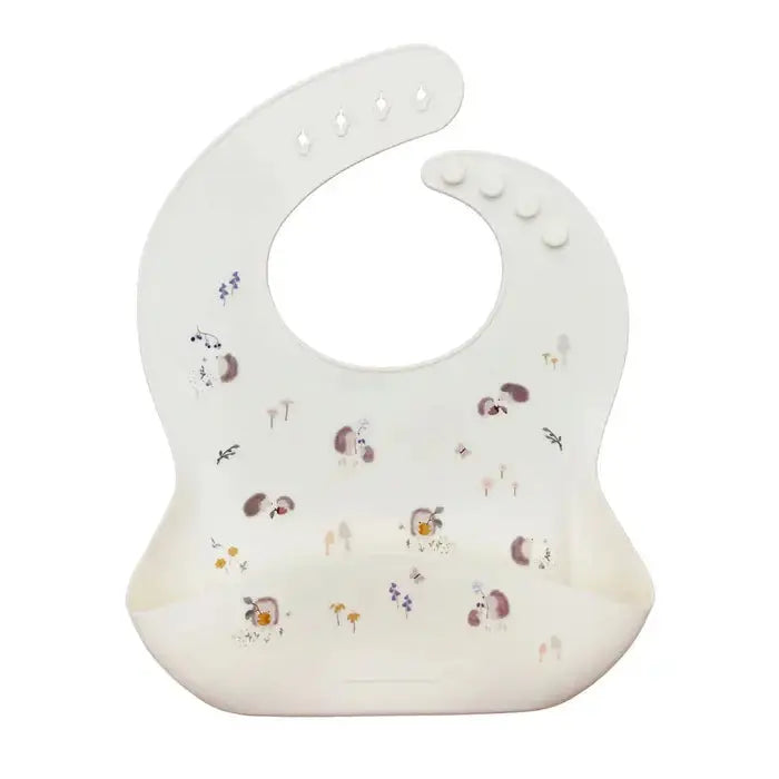 Loulou Lollipop Silicone Bib, white with pastel woodland print, curved neck with adjustable snaps and front pocket.
