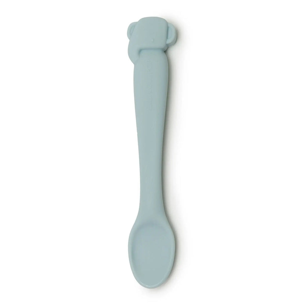 Loulou Lollipop Silicone Feeding Spoon in soft blue silicone with a curved, easy-grip handle for comfortable feeding.