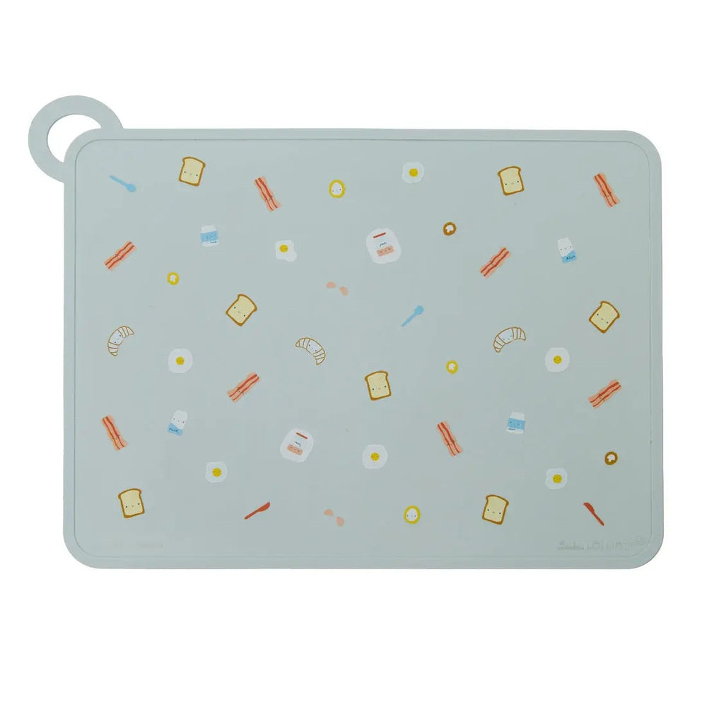 Loulou Lollipop Silicone Placemat in pale blue, spread flat with playful food icons for toddlers.