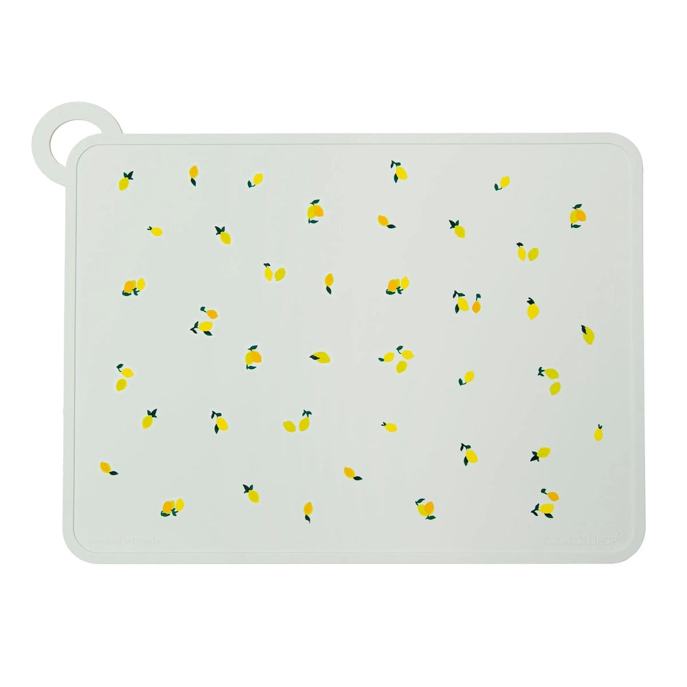 LOULOU LOLLIPOP Silicone Placemat, white with yellow lemon print, laid flat to showcase its silicone surface.