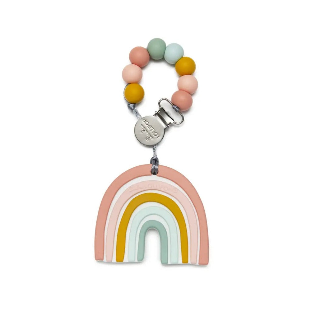 Loulou Lollipop Silicone Teether Set with pastel bead chain and rainbow arc pendant clipped for baby use.