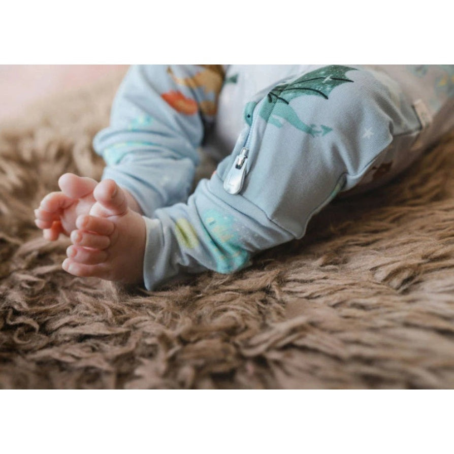 Loulou Lollipop Sleeper Magical Dragons; cozy blue dragon-print baby sleepwear, tiny feet on a fluffy rug.