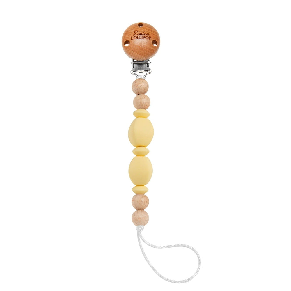 Loulou Lollipop Soleil Clip pacifier holder with yellow silicone beads and natural wood beads, clipped to clothing.