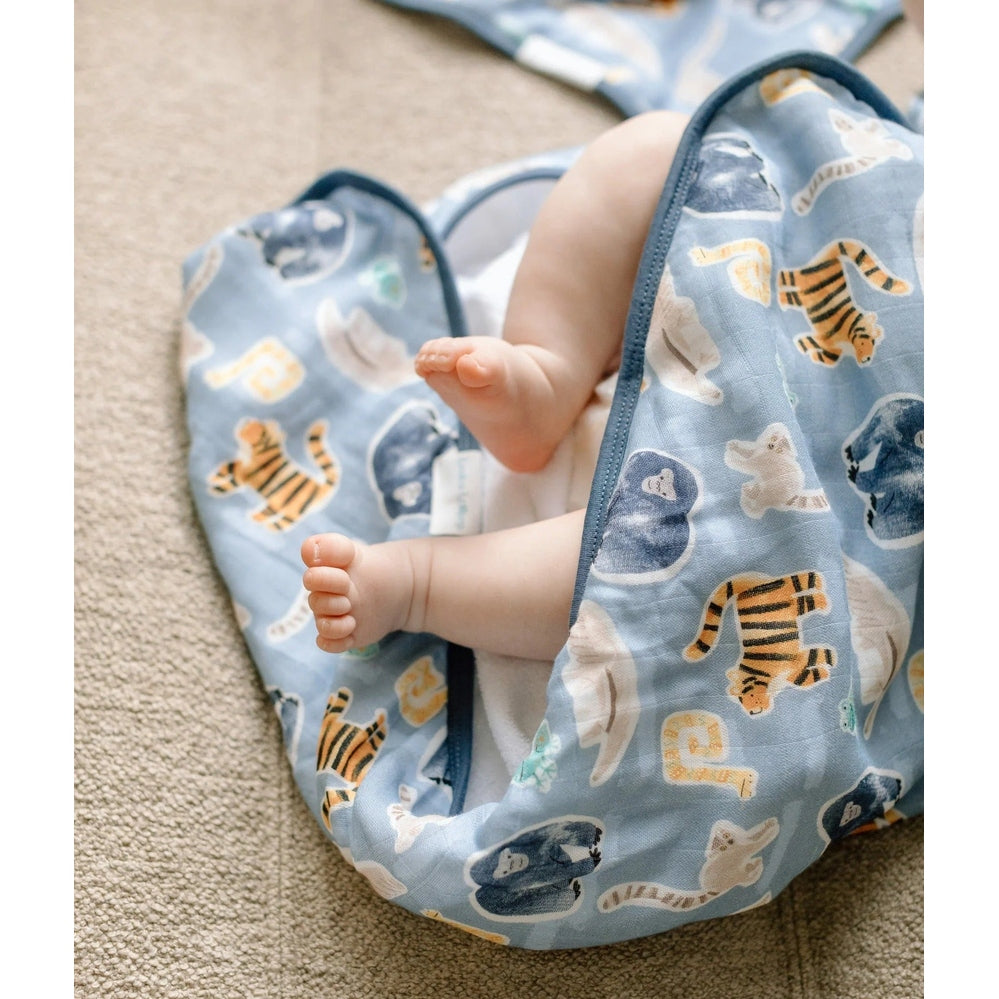 Loulou Lollipop TENCEL Sleep Bag 1.0 TOG Jungle Friends; baby’s feet peek out of a soft blue sleep bag with jungle animals.