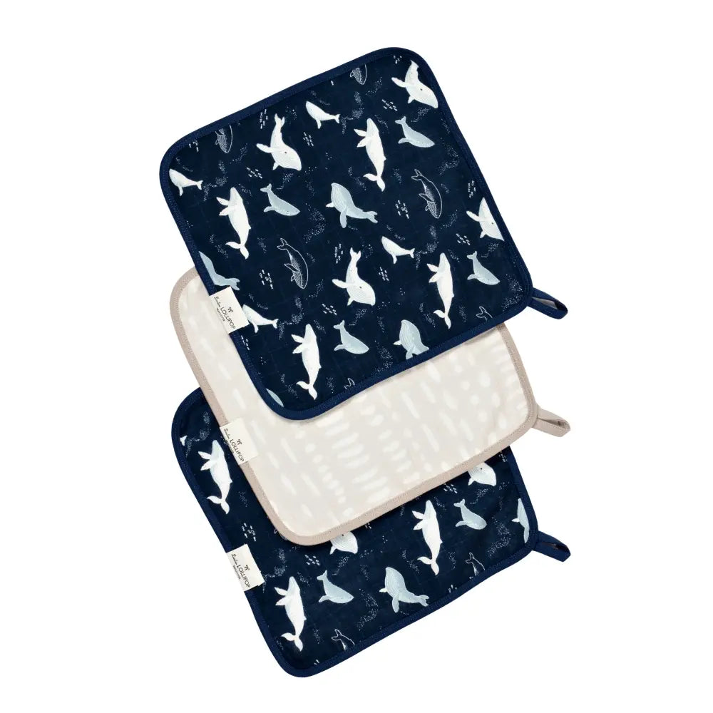 Loulou Lollipop Washcloth 3 Pieces Set in navy with white whale print, stacked to reveal beige reverse.