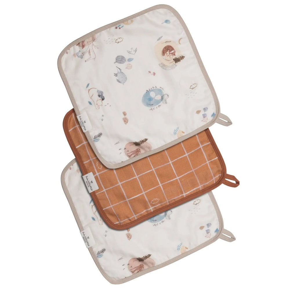 Loulou Lollipop Washcloth 3-piece set, white animal-print with beige trim and terracotta grid, laid out for bath