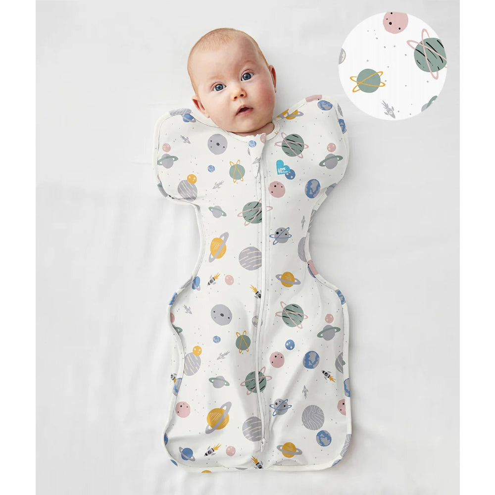 Love To Dream Swaddle Up Cotton 0.2 Tog Rocket White Space baby swaddle worn by infant with space-print zipper front