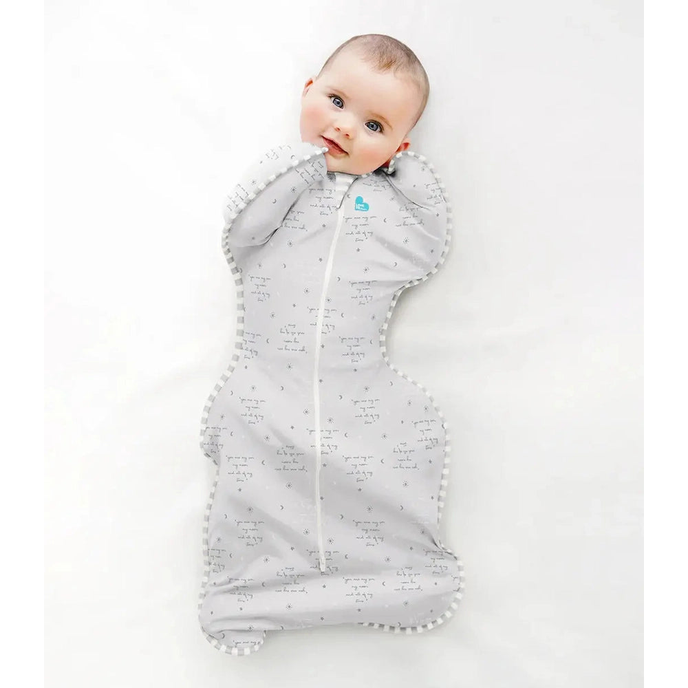 Love To Dream Swaddle Up Cotton 0.2 Tog You Are My Grey baby swaddle; light grey fabric with white trim as baby lies comfortably.