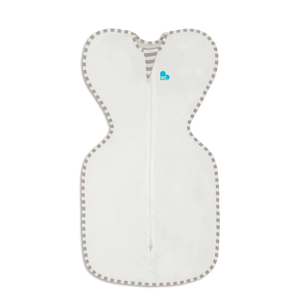 Love To Dream Swaddle Up Original Cotton 1.0 Tog cream swaddle laid flat with a front zipper and striped trim.