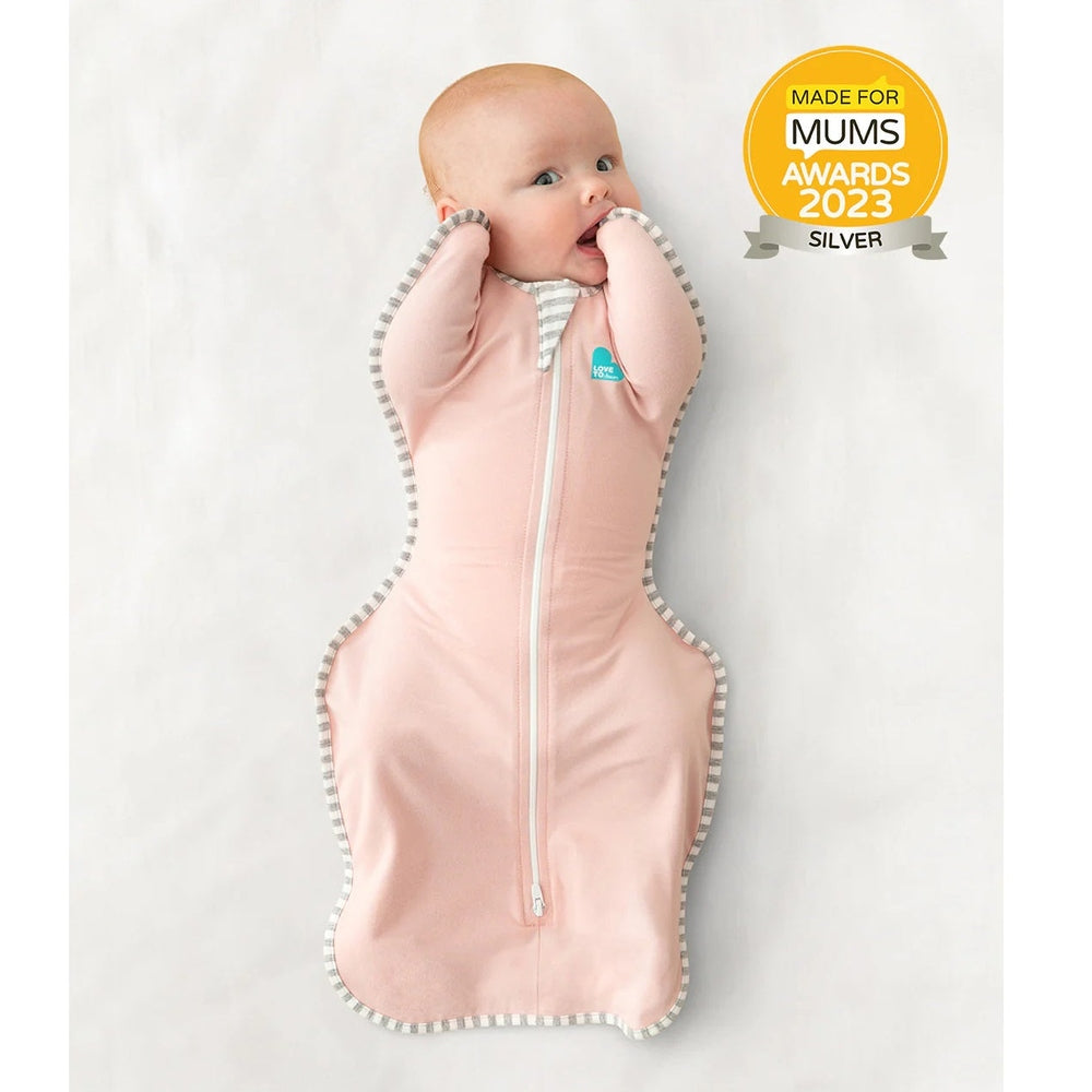 Love To Dream Swaddle Up Original Cotton 1.0 Tog Dusty Pink swaddles baby, zipper closed, grey striped edging.
