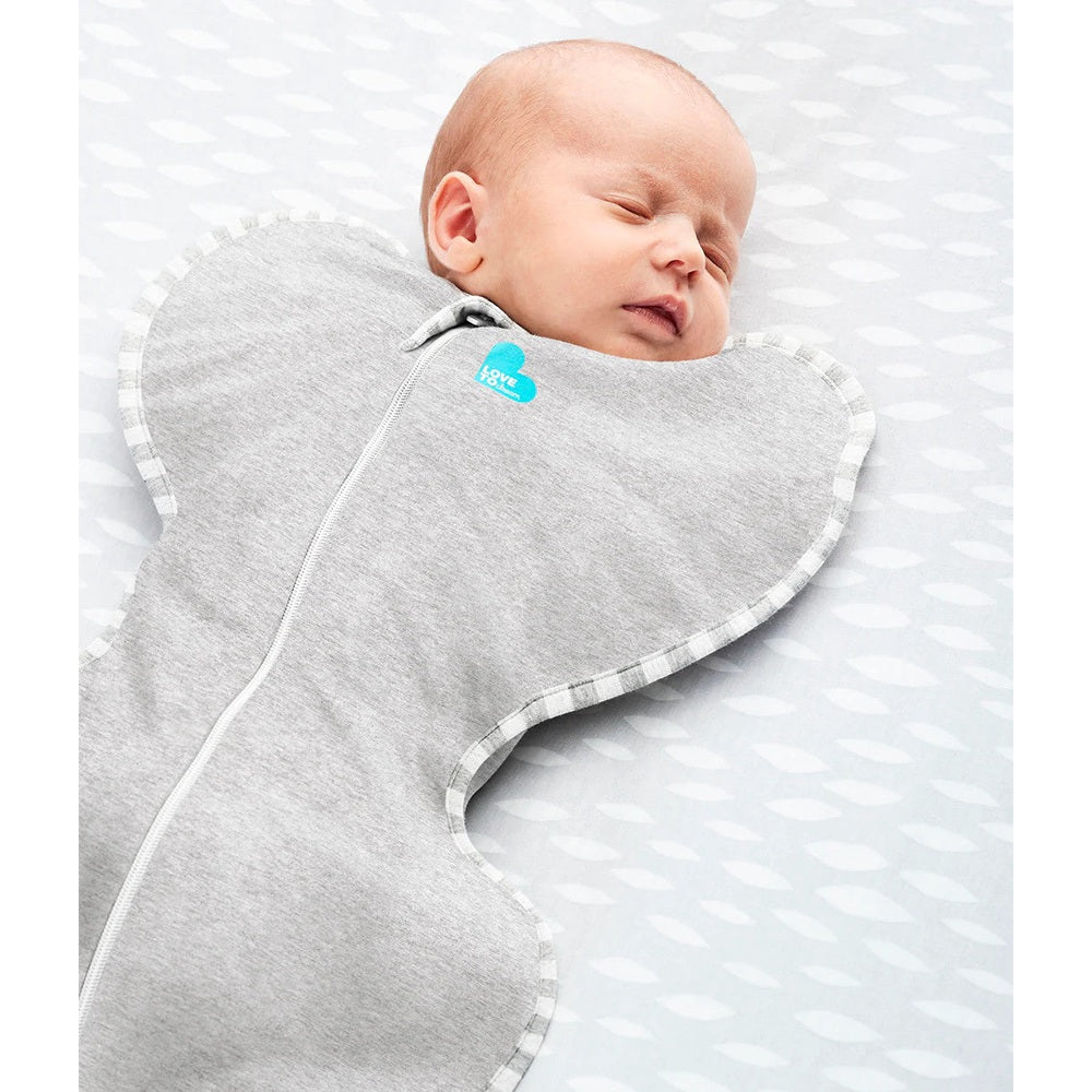 Love To Dream Swaddle Up Original Cotton 1.0 Tog Grey, snug baby sleeping as zipper seals the swaddle.