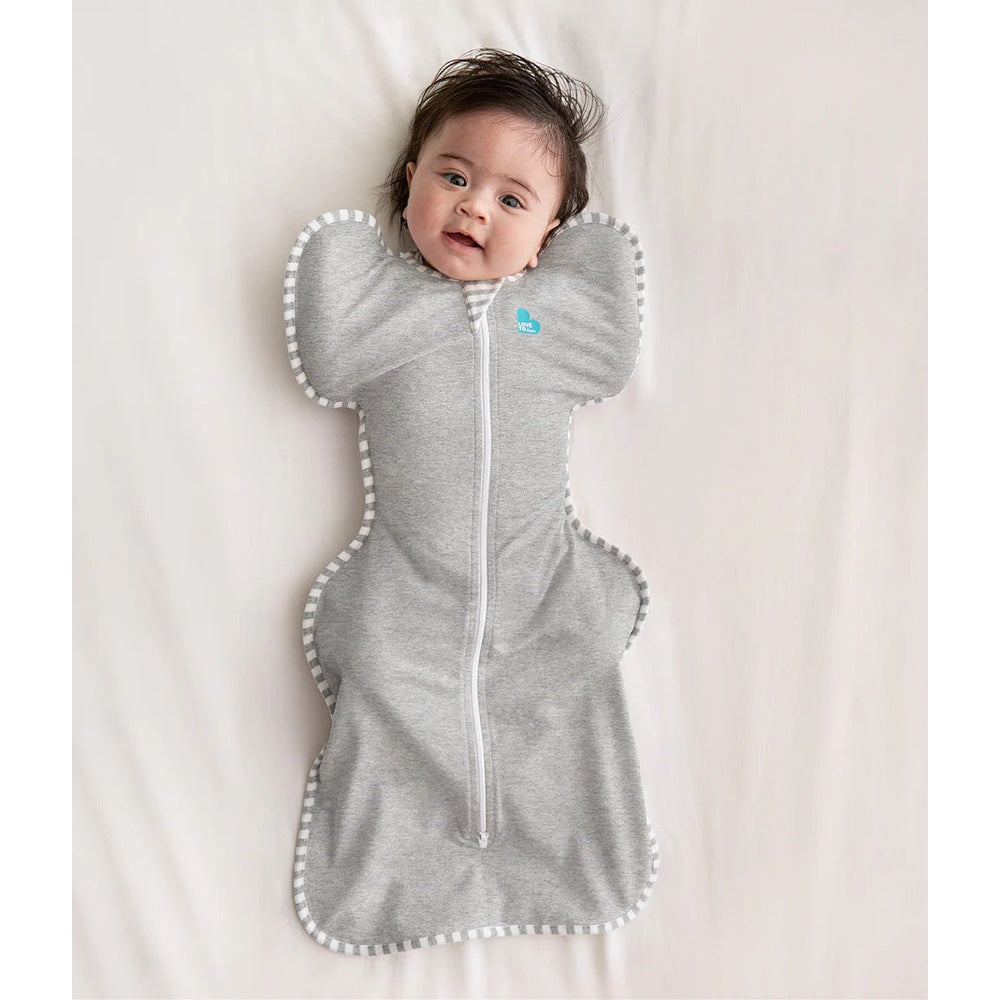Love To Dream Swaddle Up Original Cotton 1.0 Tog grey swaddle, baby with arms up secured by front zipper.
