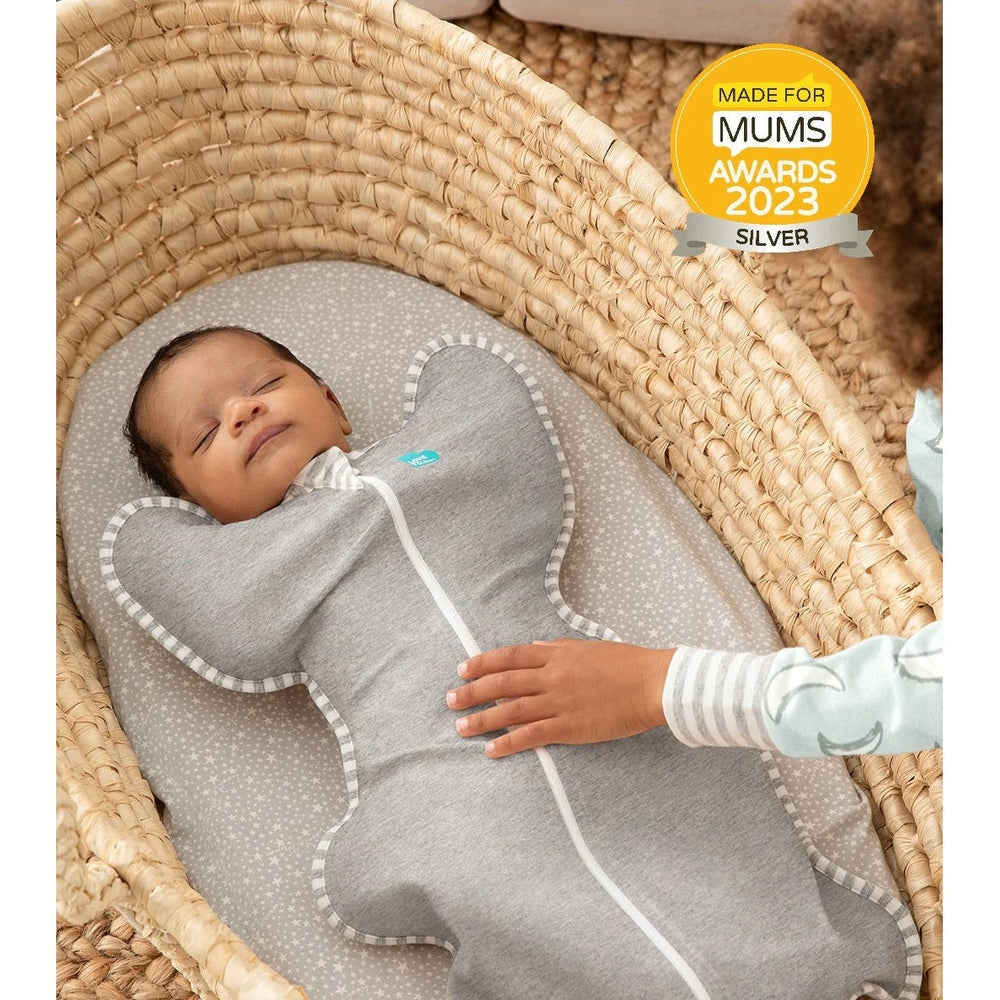 Love To Dream Swaddle Up Original Cotton 1.0 Tog Grey, baby snug in a winged swaddle in a woven bassinet.