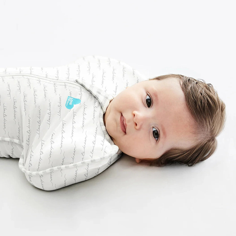 Love To Dream Swaddle Up Original Cotton 1.0 Tog White Dreamer swaddling a baby for snug sleep.