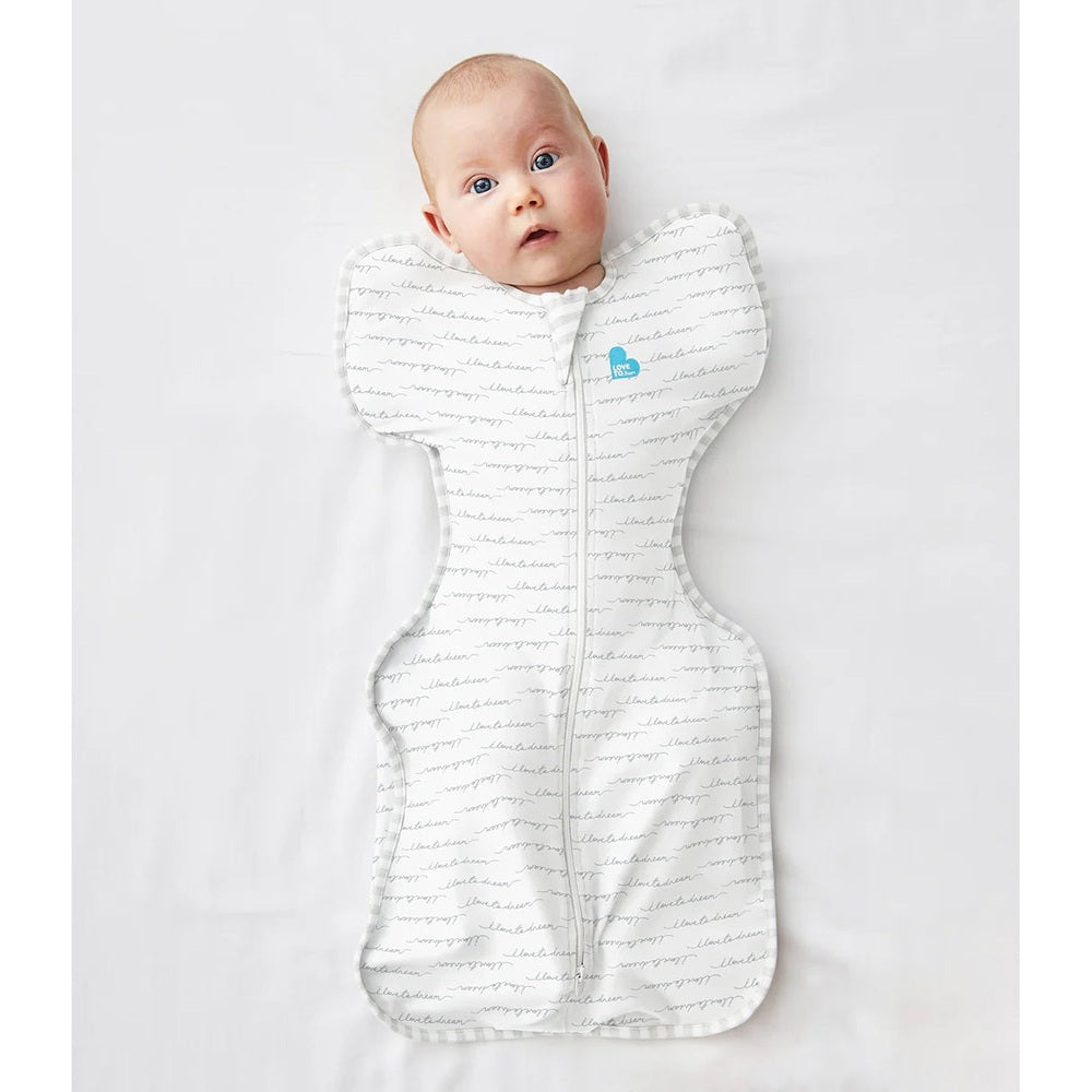Love To Dream Swaddle Up Original Cotton 1.0 Tog white baby swaddle worn by a newborn, winged silhouette and front zip.
