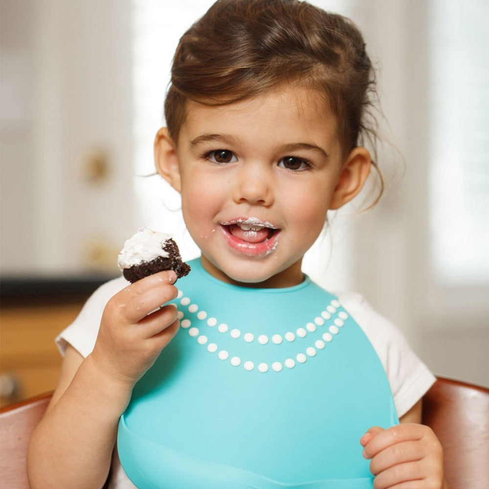 Make My Day blue pearl baby bib with white bead trim; toddler eating cupcake