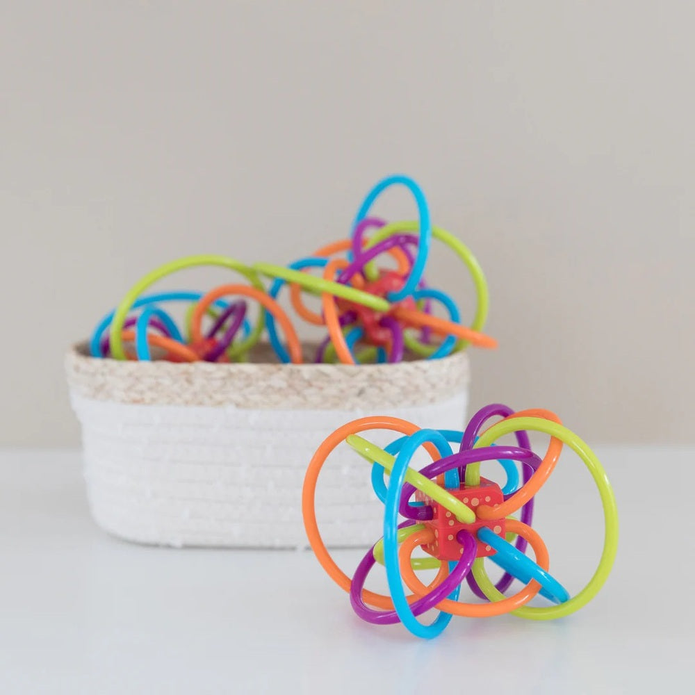 Manhattan Toy Winkel Rattle sensory teether toy, bright multi-color loops twined into a graspable teething ball.