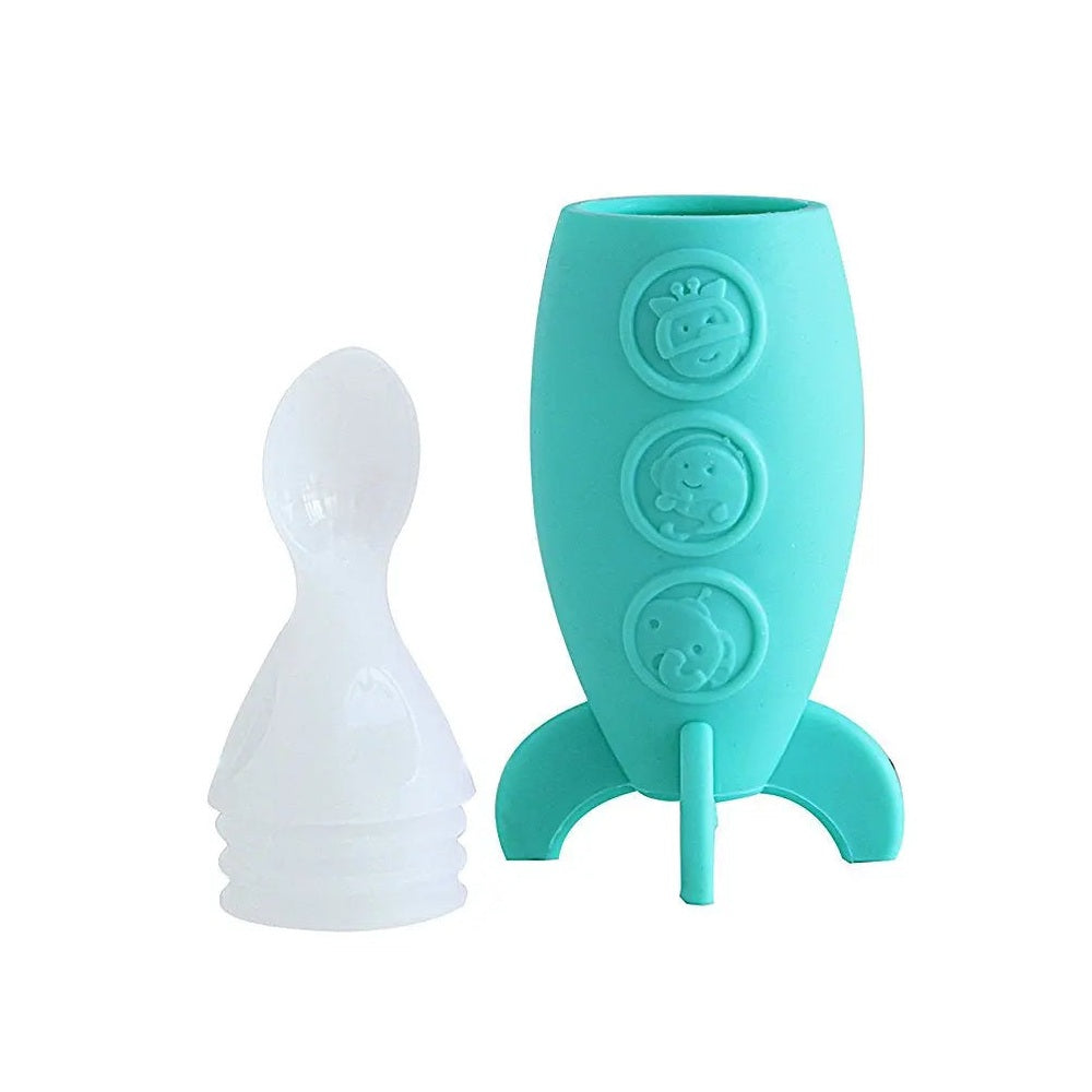 Marcus & Marcus Feeding Spoon Dispenser Rocket in teal silicone, with a white spoon leaning beside it.
