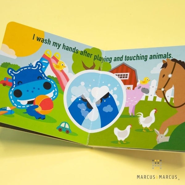 Marcus & Marcus I Can Wash My Hands educational toy featuring a bright farm scene with a blue character and various animals