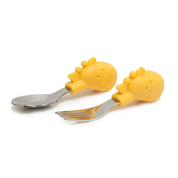 Marcus & Marcus Palm Grasp Fork and Spoon set with yellow animal handles lying on a white surface.