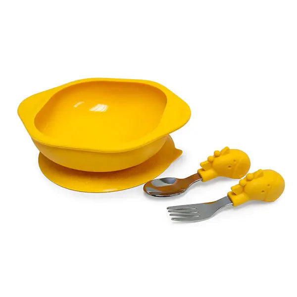 Marcus & Marcus Toddler Mealtime Set: bright yellow silicone bowl and plate with dinosaur-handled spoons and forks laid out for a toddler meal