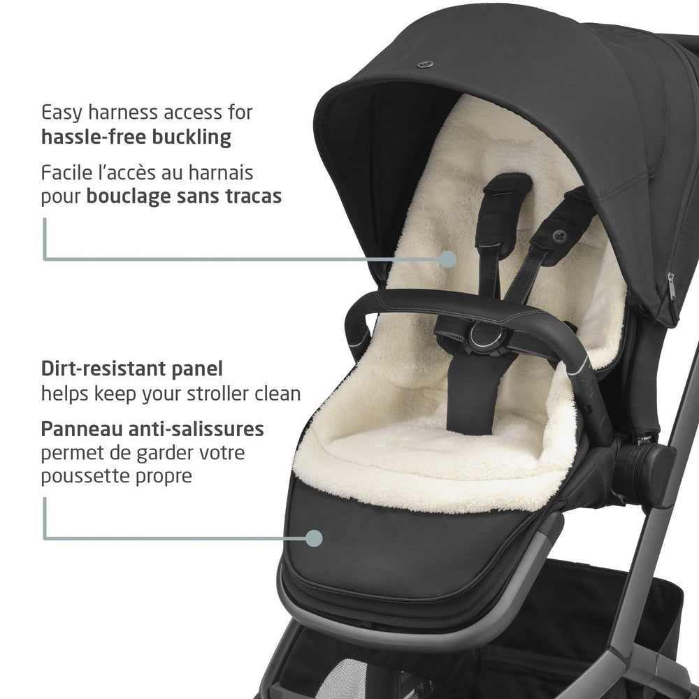 MAXI COSI 2 In 1 Footmuff Twillic Black on a stroller, showing plush lining and harness access with dirt-resistant panel.