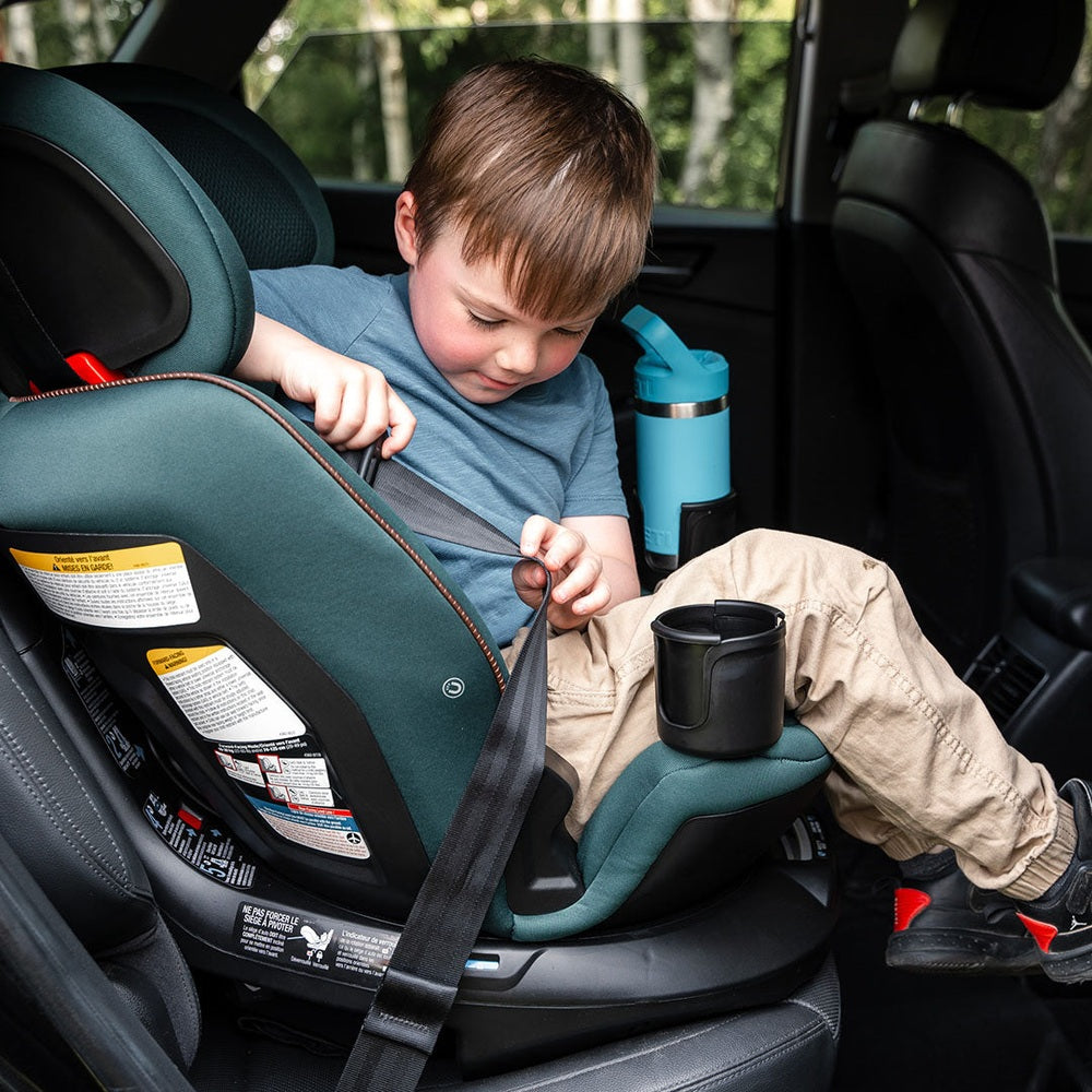 Maxi-Cosi Andi 360 convertible car seat in teal, child buckling harness inside a car