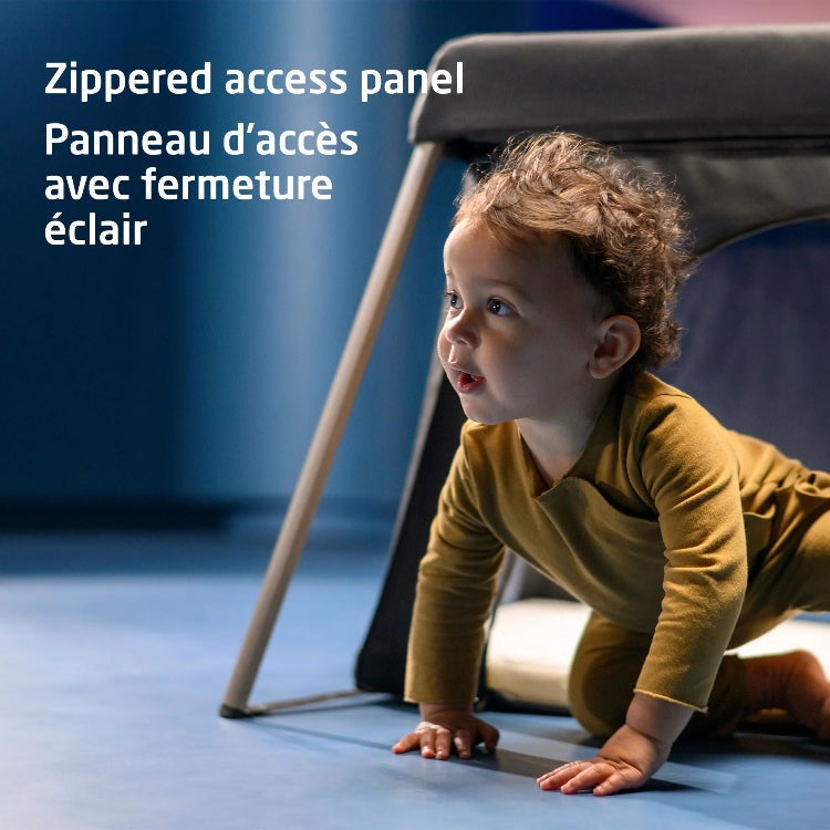 Maxi Cosi Calao Travel Crib with light frame and dark fabric, baby crawling underneath