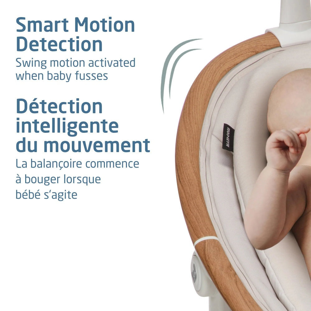 Maxi-Cosi Cassia Swing with wooden frame and beige fabric, baby seated and swinging.