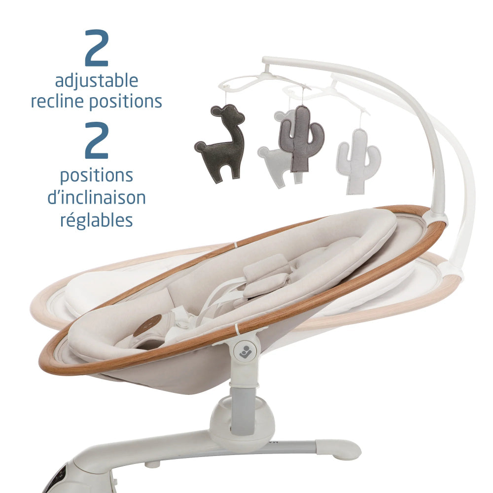 MAXI COSI Cassia Swing with wood-accent seat; two adjustable recline positions shown by hanging plush toys.