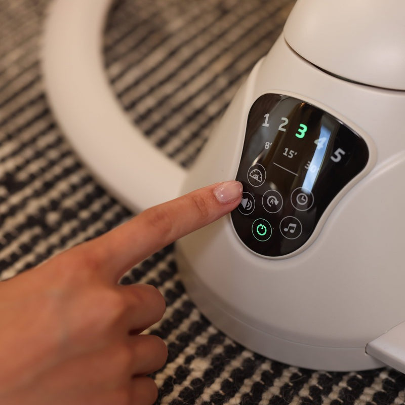 Maxi Cosi Cassia Swing control panel with illuminated power button; white baby swing.